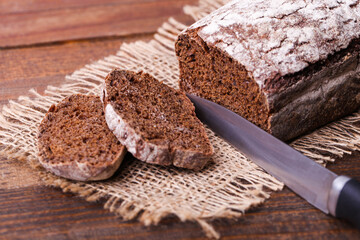 Loaf of rectangular rye bread on burlap
