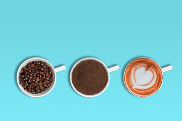 Coffee beans, ground coffee and cup of latte coffee over blue background with copy space for text.