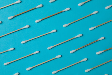 Flat lay with cotton swabs on blue background