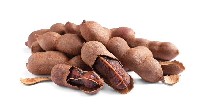 Delicious ripe tamarinds on white background. Exotic fruit