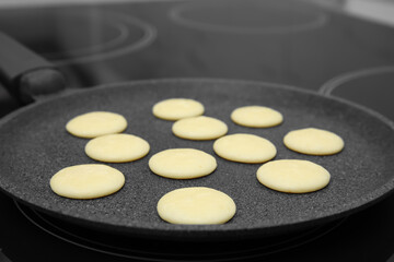Obraz na płótnie Canvas Frying tasty cereal pancakes on modern stove