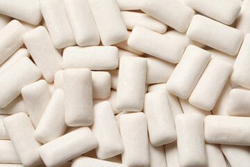 Many chewing gum pieces as background, top view