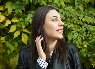 Beautiful young smiling woman against the background of nature. Portrait.