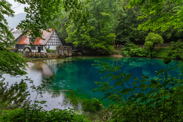 Fototapeta premium Touristic highlight Blautopf in the old town of Blaubeuren in german region swabian alb