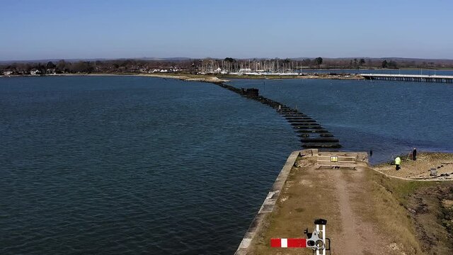 The remains of the Hayling Island Railway Bridge aerial of this wooden bridge that was closed in 1963 and was a branch line from Havant to Hayling Island, the old railway signal  is still in place.