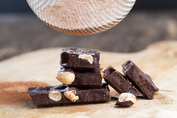 divided into parts chocolate bar with whole nuts