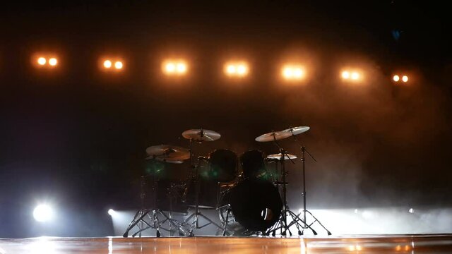 Drums on a stage in yellow light