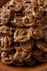 Vertical food background of Chebakia traditional Moroccan sweets cooked for the holy Ramadan month with a ceramics plate. 