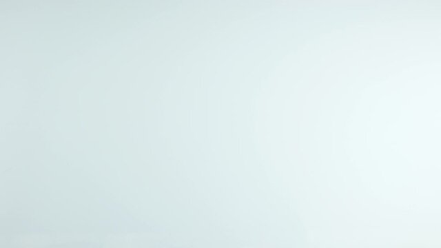 Hand picking up from a white board syringe and sthetoscope. Rapid action showing emergency and hurry in order to cure somebody or inoculate vaccine.