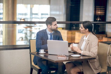 Business partners sitting at the table and discussing the project