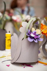Paper flowers in decorative paper teapots. Chamomile is handmade from paper. Selective focus