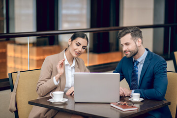 Business partners sitting at the table and having a brainstorming