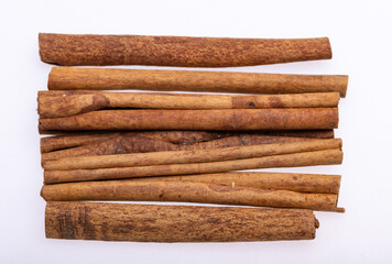 Cinnamon sticks, classic spice from the inner bark of tropical Asian trees, flavorful and aromatic for cooking, baking, health food and medicinal uses.