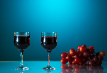 Two glasses of wine on a beautiful blue background. holiday mood