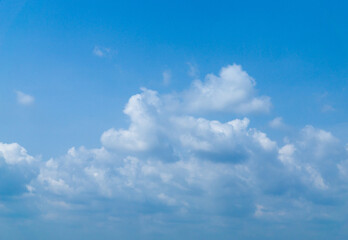 Fototapeta premium Beautiful view of blue sky with clouds. Beautiful shapes, partly cloudy. Colorful sunset. Natural sky background texture, beautiful color. Bright landscape in the blue sky.