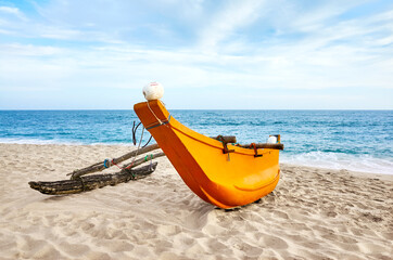 Small fishing boat on an empty beach, Sri Lanka.