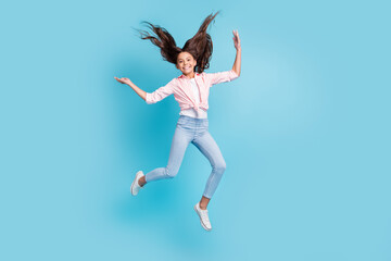 Full size photo of energetic cheerful school person jumping hair flying good mood isolated on blue color background