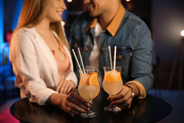 Man and woman flirting with each other in bar, closeup