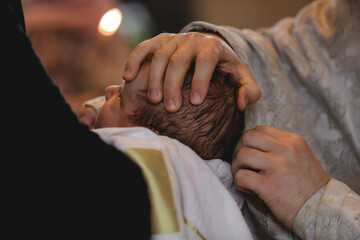 Man holding adorable baby in church during baptism ceremony, closeup