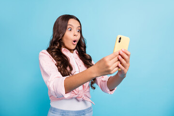 Photo of young beautiful shocked amazed surprised girl using smartphone sees dislike isolated on...