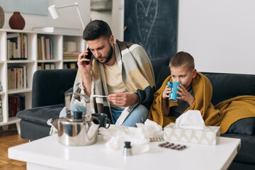 father and son catch a cold. they are sitting at home