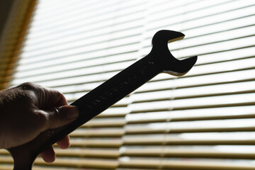 Hand holding a wrench with backlit