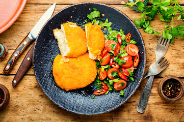 Chicken kiev cutlet with salad