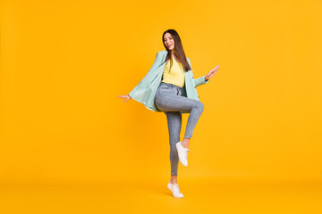 Fototapeta na wymiar Full length photo of funny pretty young woman wear teal blazer dancing isolated yellow color background