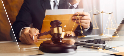 Business and lawyers discussing contract papers with brass scale on desk in office. Law, legal services, advice, justice and law concept picture with film grain effect