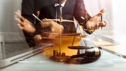 Business and lawyers discussing contract papers with brass scale on desk in office. Law, legal services, advice, justice and law concept picture with film grain effect