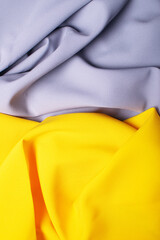 Beautiful yellow and grey satin as a background, bright abstraction.