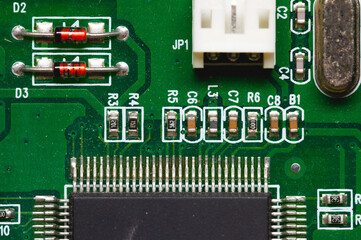 Close-up of a factory printed circuit board of electronics with pin tracks. Electronic background green tint