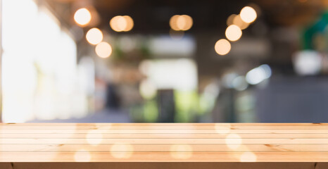 Empty wooden table top with lights bokeh on blur restaurant background