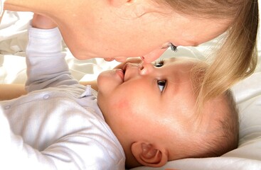 baby in mother's arms and been cared for after having a good sleep in bed stock photo