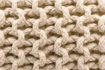 The pattern is formed by weaving a coarse thread as a background, texture.