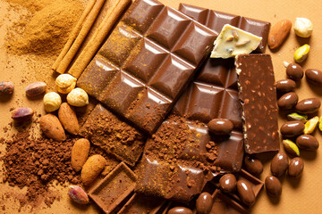 White and milk chocolates. Almond, pistachio, hazelnut.. background, texture..
