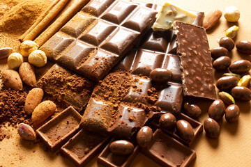 White and milk chocolates. Almond, pistachio, hazelnut.. background, texture..