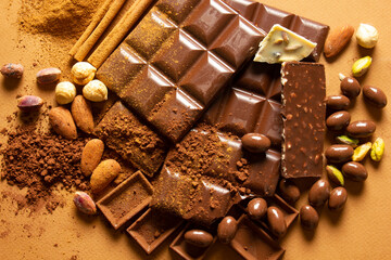 White and milk chocolates. Almond, pistachio, hazelnut.. background, texture..