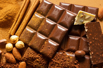 White and milk chocolates. Almond, pistachio, hazelnut.. background, texture..
