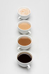 different freshy made coffee drinks with milk on white