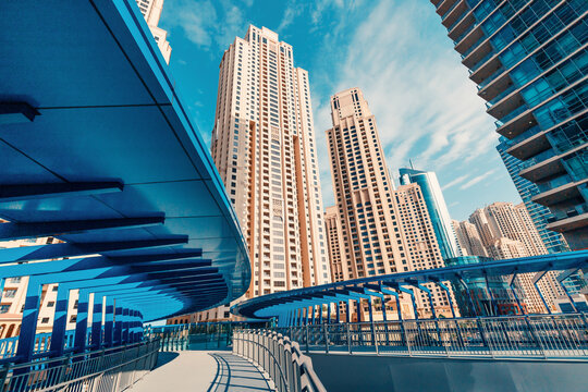 The tallest residential block in the world - Jumeirah Beach Residence and original architecture pedestrian bridge in Dubai. Residential real estate and development