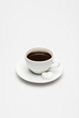 Obraz premium cup of prepared coffee and sugar cubes on saucer on white