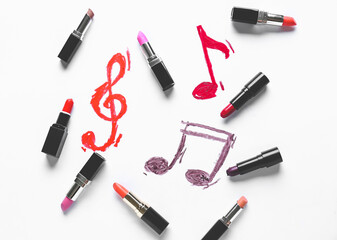 Obraz premium Drawn music notes and makeup cosmetics on white background