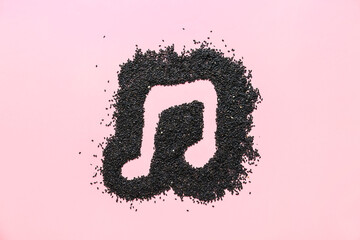 Music note drawn on black seeds against color background