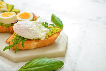 Board with tasty sandwich on white background