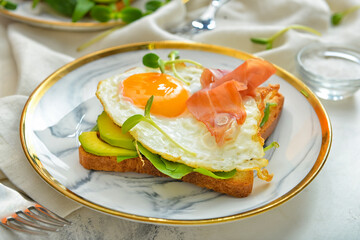 Plate with tasty sandwich on table