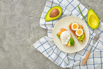 Plate with tasty sandwiches on grey background