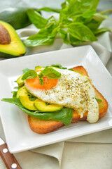 Plate with tasty sandwich on table