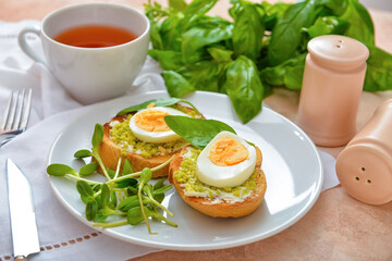 Plate with tasty sandwiches on table