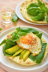 Plate with tasty fried egg, avocado and flatbread on table, closeup
